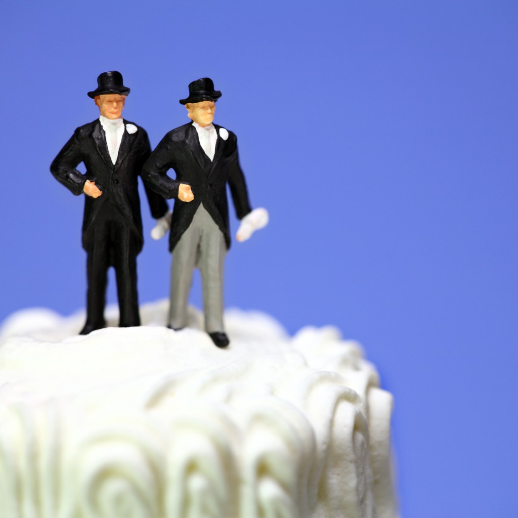 Miniature homosexual couple on a wedding cake. Gay marriage.