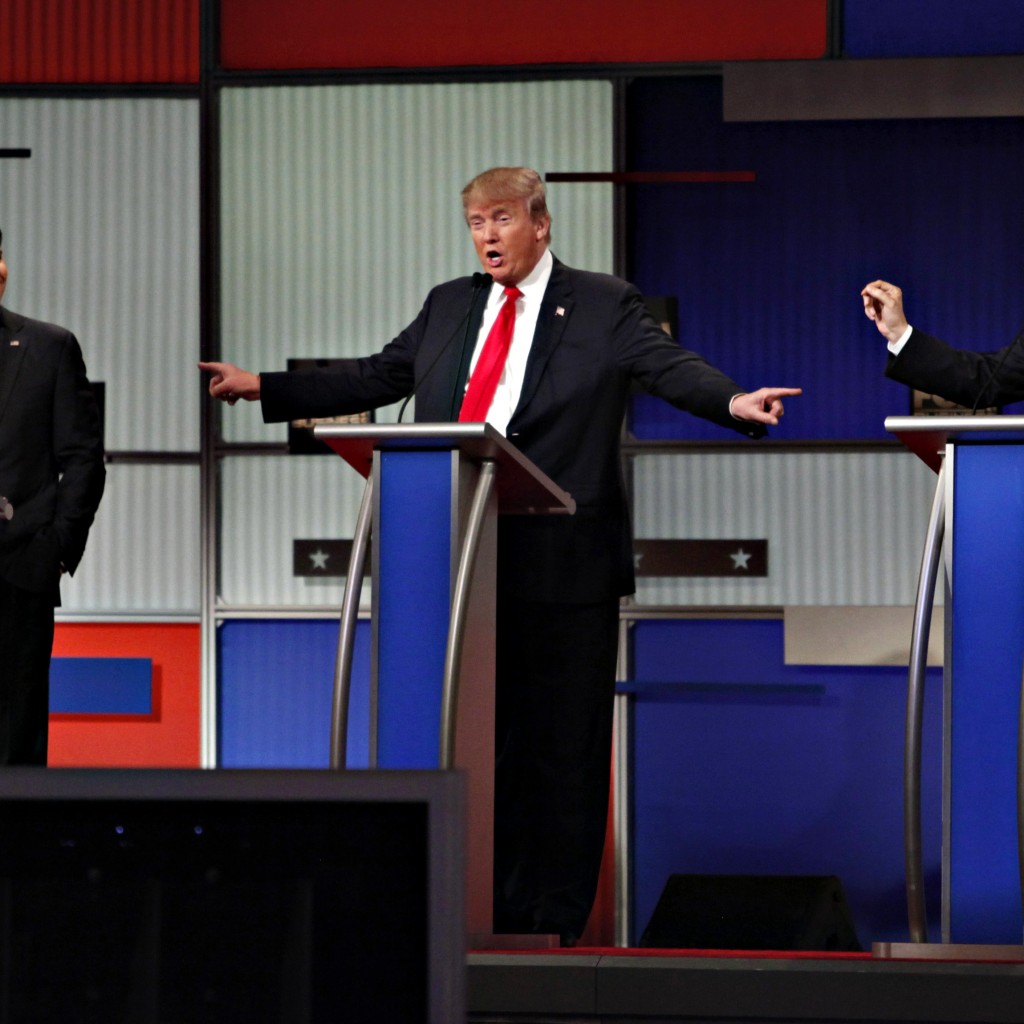 Republican U.S. presidential candidate Trump gestures towards rivals Rubio and Cruz during the Fox Business Network Republican presidential candidates debate in North Charleston