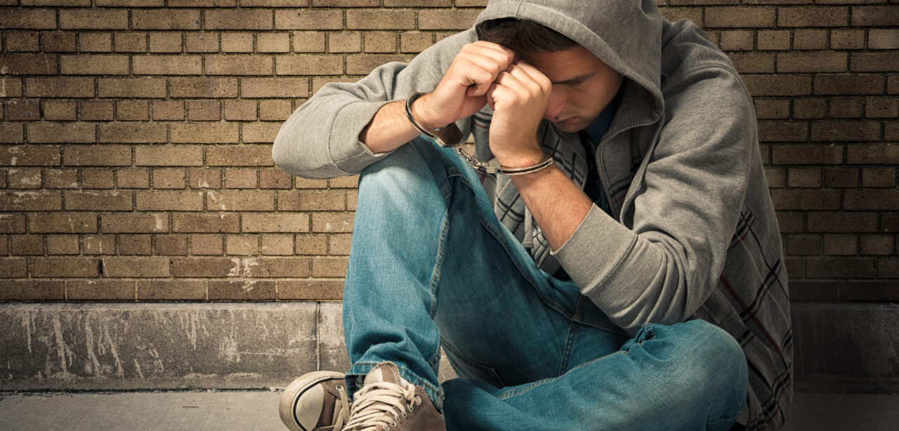 Arrested teenager with handcuffs