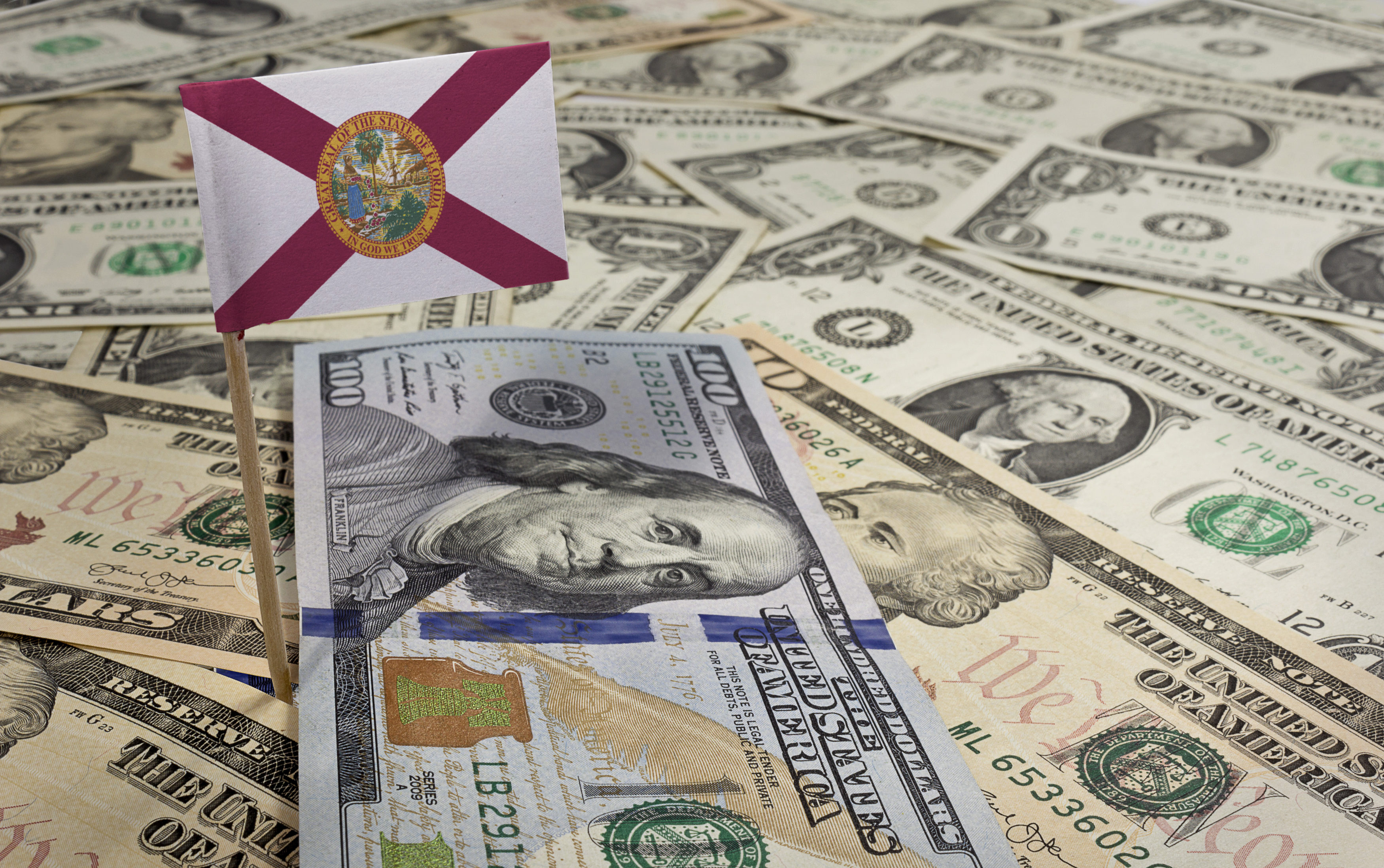 Flag of Florida sticking in various american banknotes.(series)