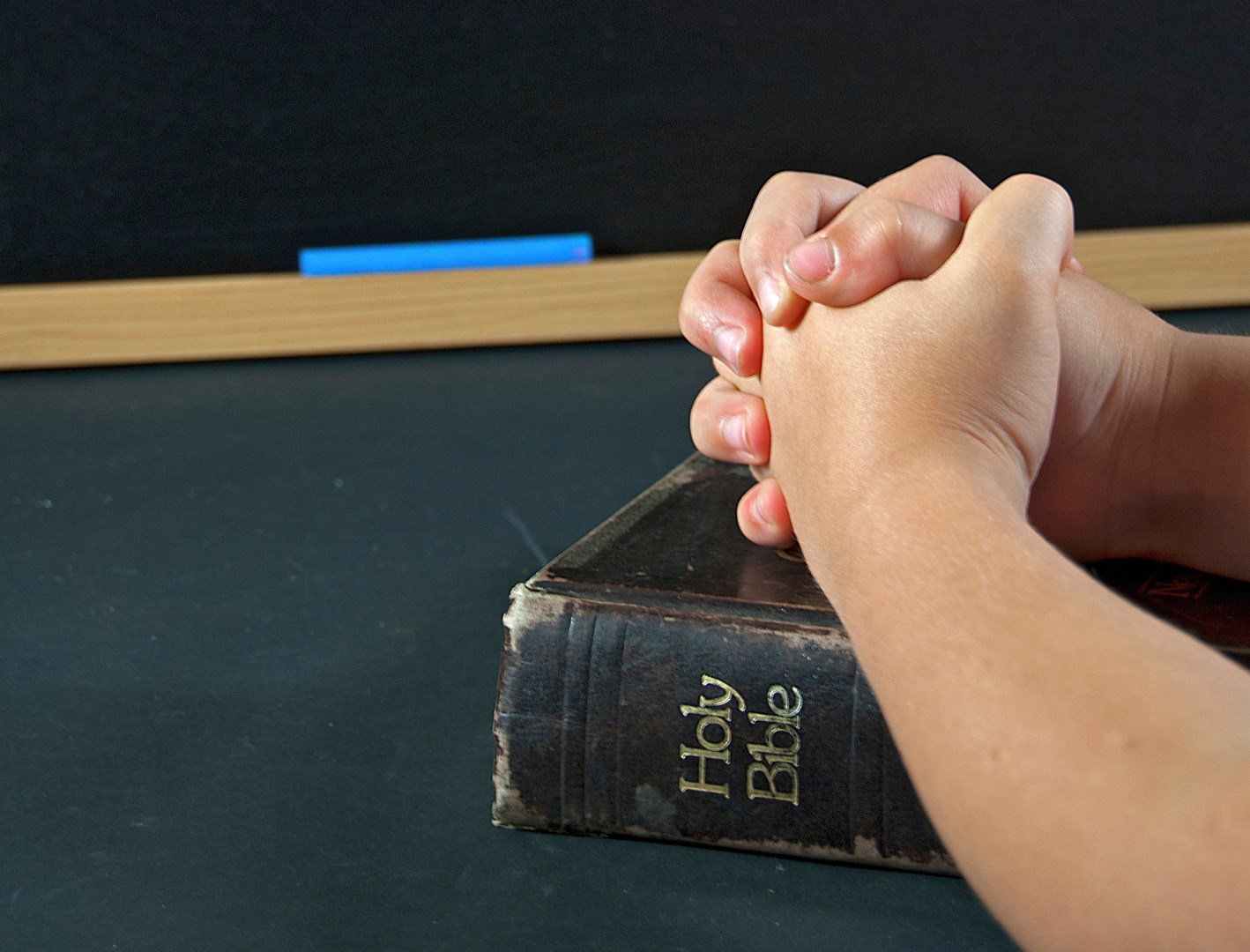 child praying in school