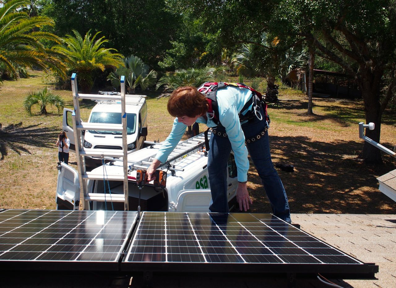 Gwen Graham on roof during Work Day