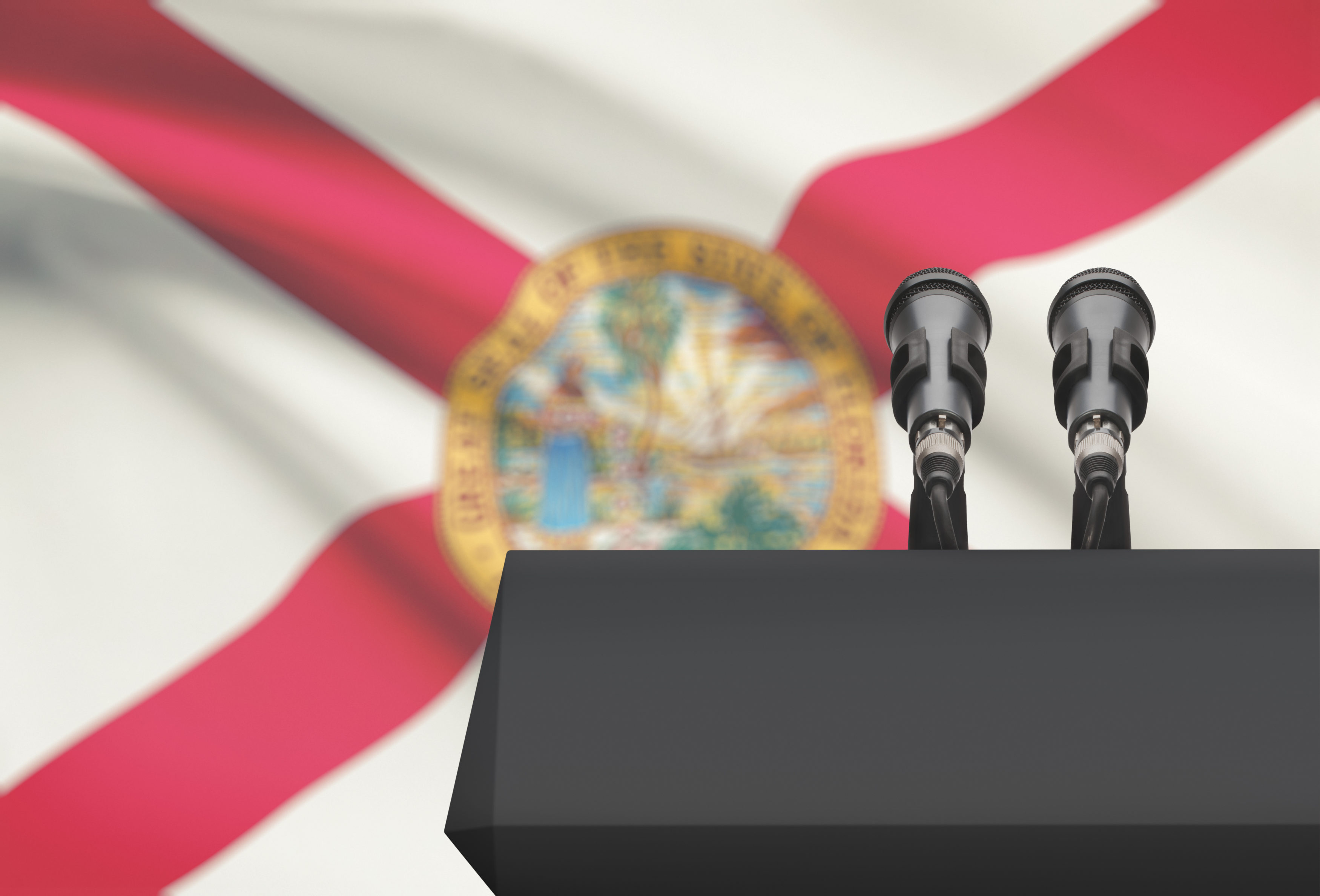 Pulpit and two microphones with USA state flag on background - Florida