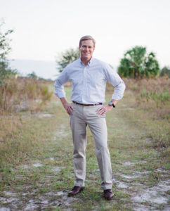 Chris Hunter, CD 12 Democratic Candidate, standing on grassy clearing (Photo pulled from official campaign website)