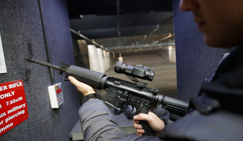 Alec Murrary holds an AR-15 assault rifle at the Ringmasters of Utah gun range