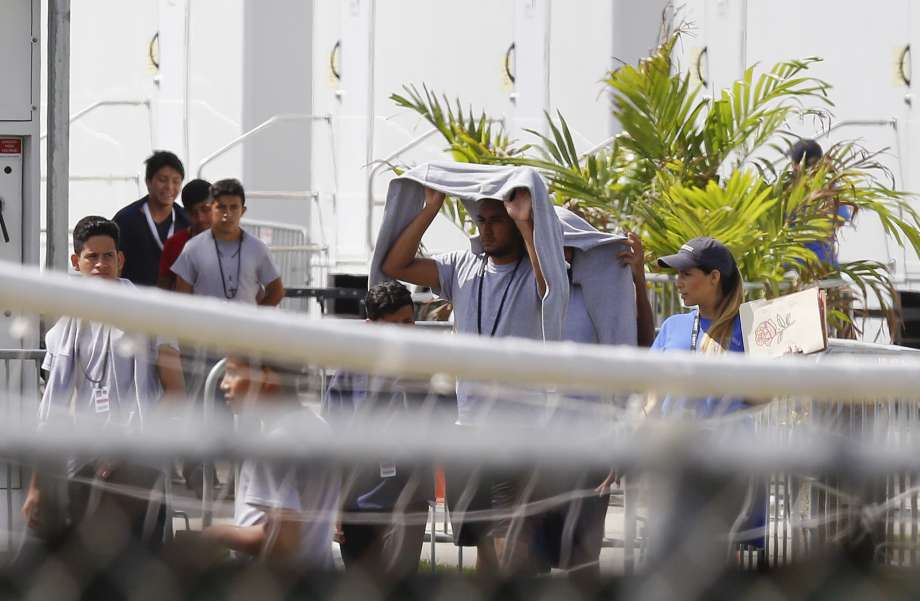 Migrant children walk outside at the Homestead Temporary Shelter for Unaccompanied Children