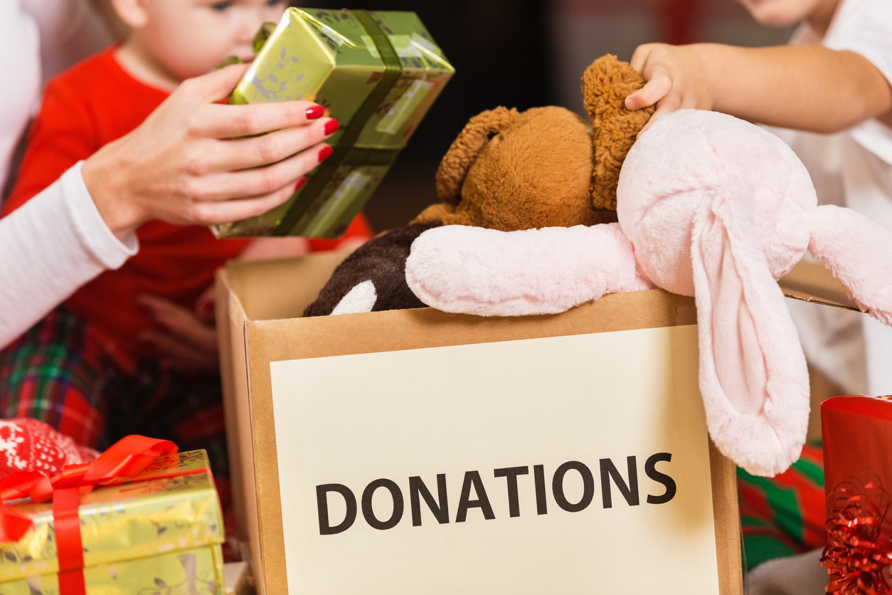 Family donating gifts and toys to charity for Christmas holiday