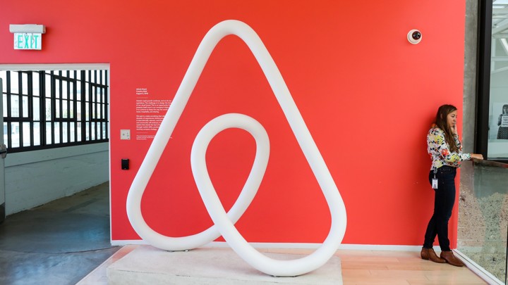 A woman talks on the phone at the Airbnb office headquarters in the SOMA district of San Francisco