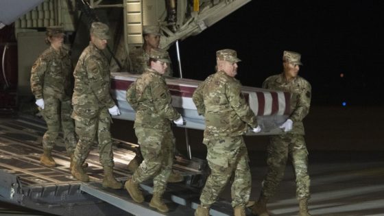 An Air Force carry team moves a transfer case containing the remains of Navy Ensign Joshua Watson on Sunday, Dec. 8, 2019, at Dover Air Force Base, Del. A Saudi gunman killed three people including 23-year-old Watson, a recent graduate of the U.S. Naval Academy from Enterprise, Ala., in a shooting at Naval Air Station Pensacola in Florida. (AP Photo/Cliff Owen)