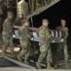 An Air Force carry team moves a transfer case containing the remains of Navy Ensign Joshua Watson on Sunday, Dec. 8, 2019, at Dover Air Force Base, Del. A Saudi gunman killed three people including 23-year-old Watson, a recent graduate of the U.S. Naval Academy from Enterprise, Ala., in a shooting at Naval Air Station Pensacola in Florida. (AP Photo/Cliff Owen)