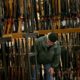 FILE - In this Nov. 29, 2019, file photo, a man looks at the shotgun section of Cabela's while shopping on Black Friday in Hazelwood, Mo. The number of background checks conducted by federal authorities is on pace to break a record by the end of this year. (Christian Gooden/St. Louis Post-Dispatch via AP)