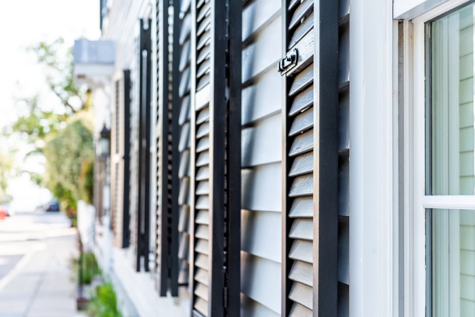 Black decorative row of window shutters closeup architecture open exterior of houses buildings or homes in Charleston, South Carolina southern city