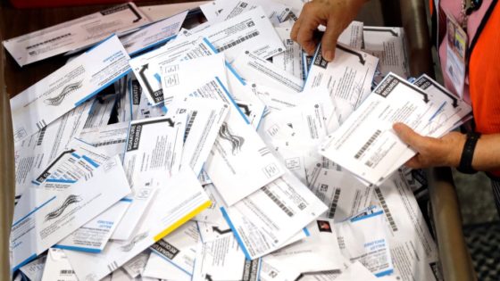 FILE - In this May 17, 2016, file photo, ballots are prepared for counting at Multnomah County election headquarters in Portland, Ore. The coronavirus has knocked presidential primaries back several weeks as officials worry about voters crowding into polling places. If the disease remains a hazard in November, Democrats say there's only one solution to preserve the November election, national voting by mail. (AP Photo/Don Ryan, File)