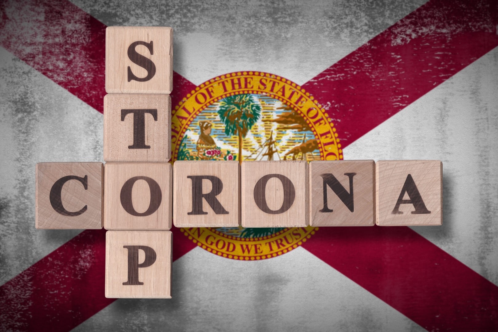 Flag of the state of Florida with wooden cubes spelling STOP CORONA on it. 2019 - 2020 Novel Coronavirus (2019-nCoV) concept art, for an outbreak occurs in Florida, US.