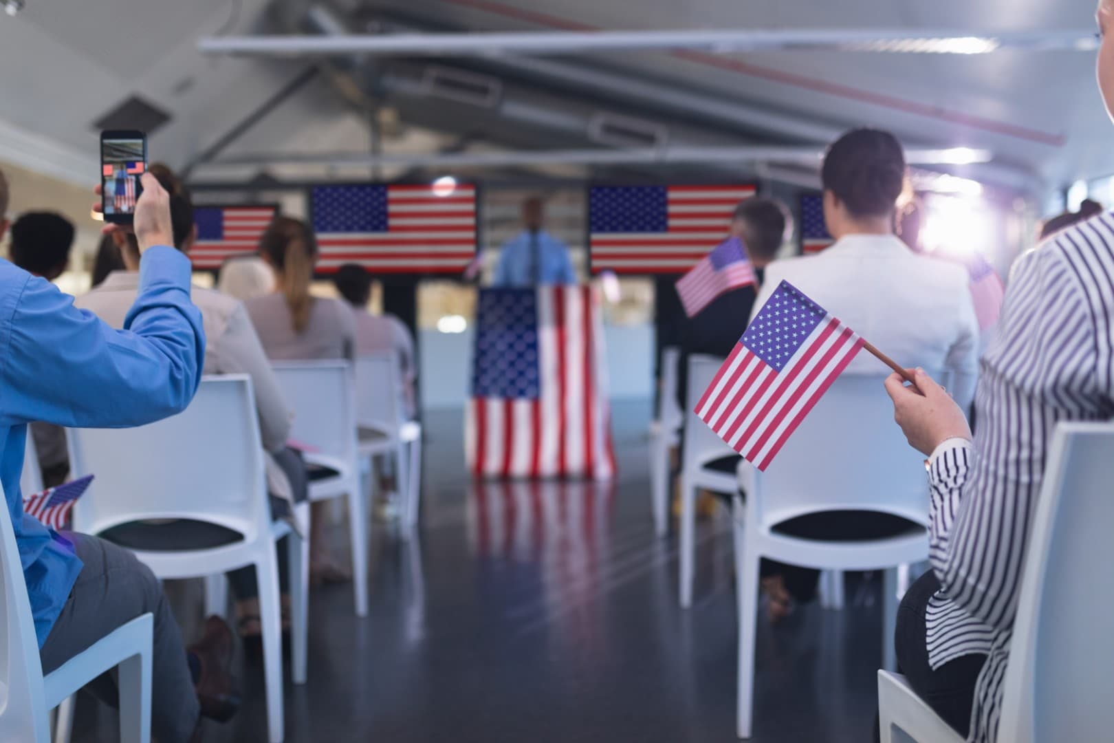 Business people waving an American flag in business seminar