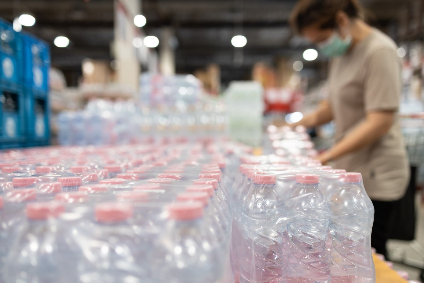 Lot of plastic packaging of fresh water,people wearing face mask,choosing fresh water,beverage and food,woman panic buying and hoarding during the Covid-19,Coronavirus epidemic,preparing for pandemic