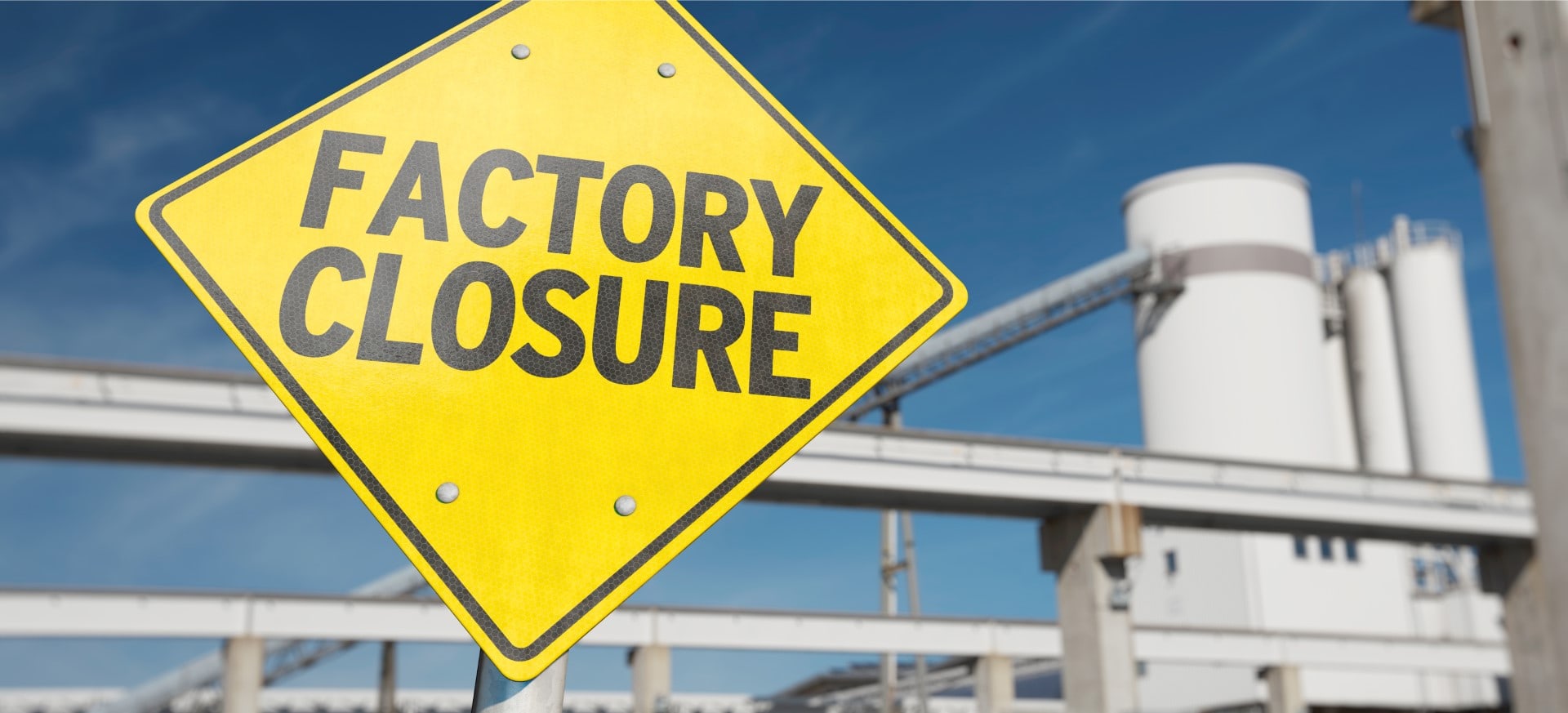 A sign with the word "FACTORY CLOSURE"