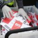 FILE - In this March 10, 2020, file photo wearing gloves, a King County Election worker collect ballots from a drop box in the Washington State primary, in Seattle. But the 2020 presidential election is creeping ever closer, and there are no signs yet of pandemic abating, nor any word on when Americans on orders to stay home can resume normal life, and so lawmakers are trying to figure how to allow for voting in a world where face-to-face contact causes anxiety at the least, and sickness and death at the most. (AP Photo/John Froschauer, File)