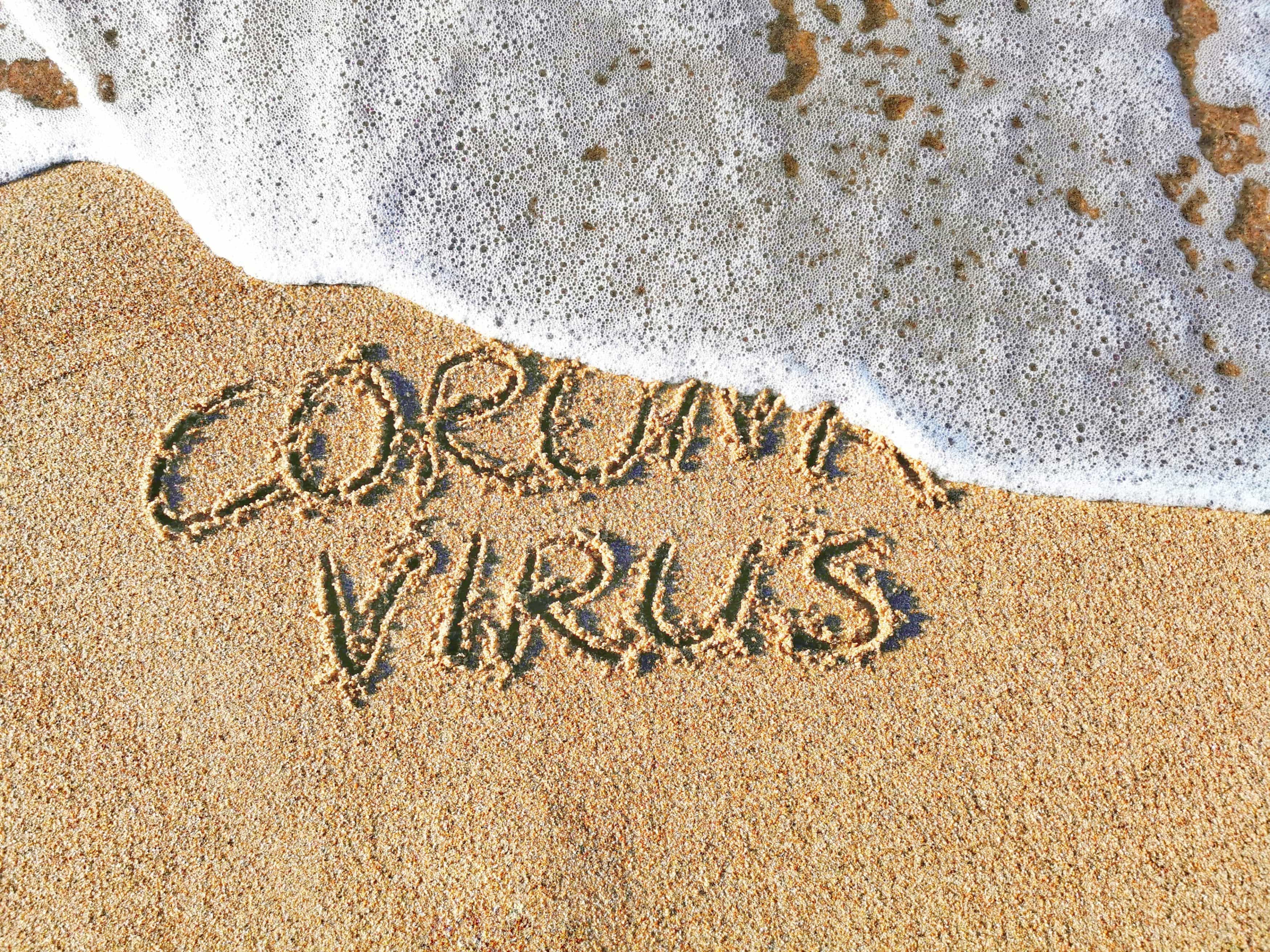 Coronavirus concept. "Stop Coronavirus" written on sand.