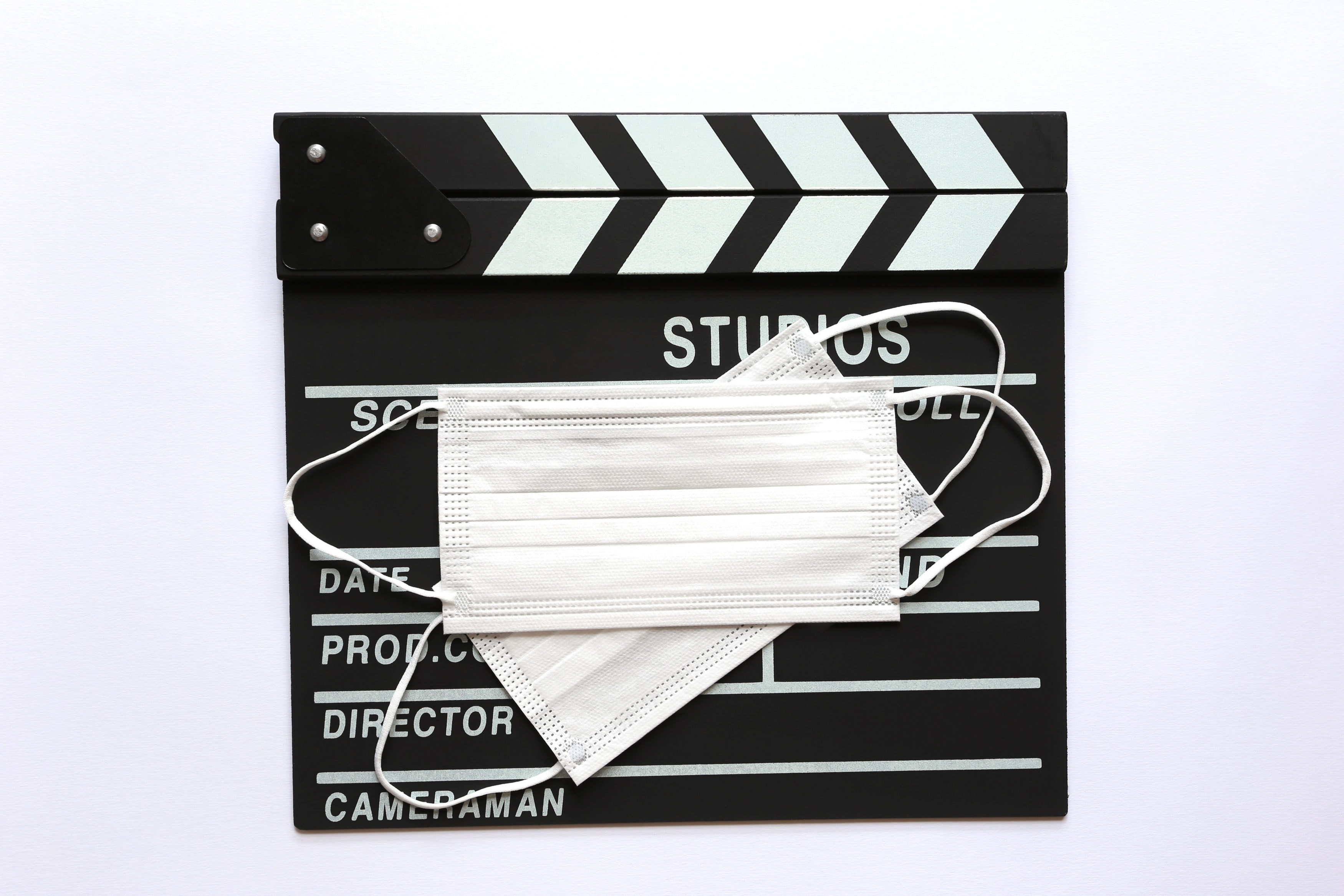 Amedical face mask on Clapperboard or Film slate on white background