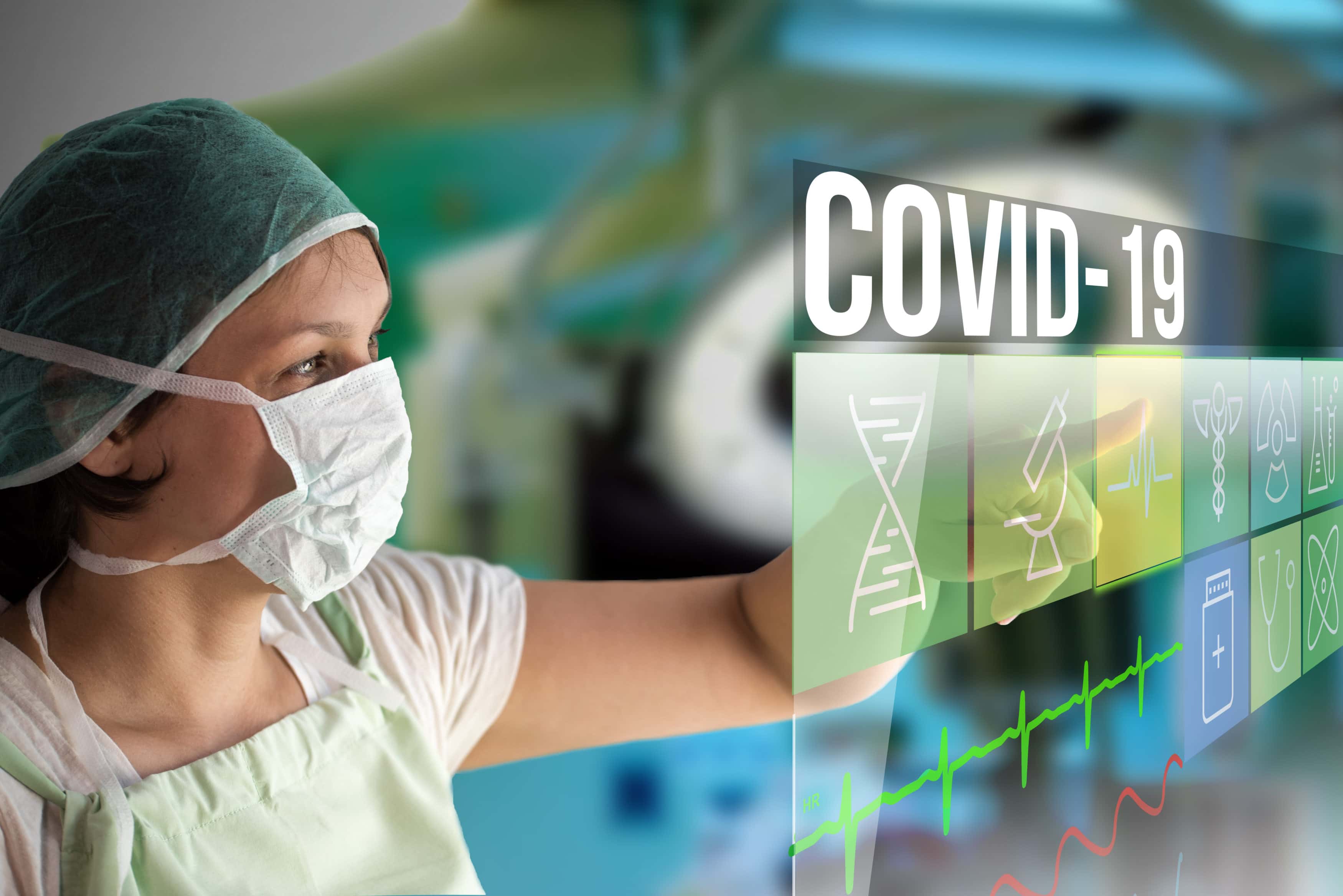 Coronavirus Covid-19 concept image with doctor woman using futuristic touch monitor interface with text and icons with surgery operating room on background looking for vaccine with mask on her face