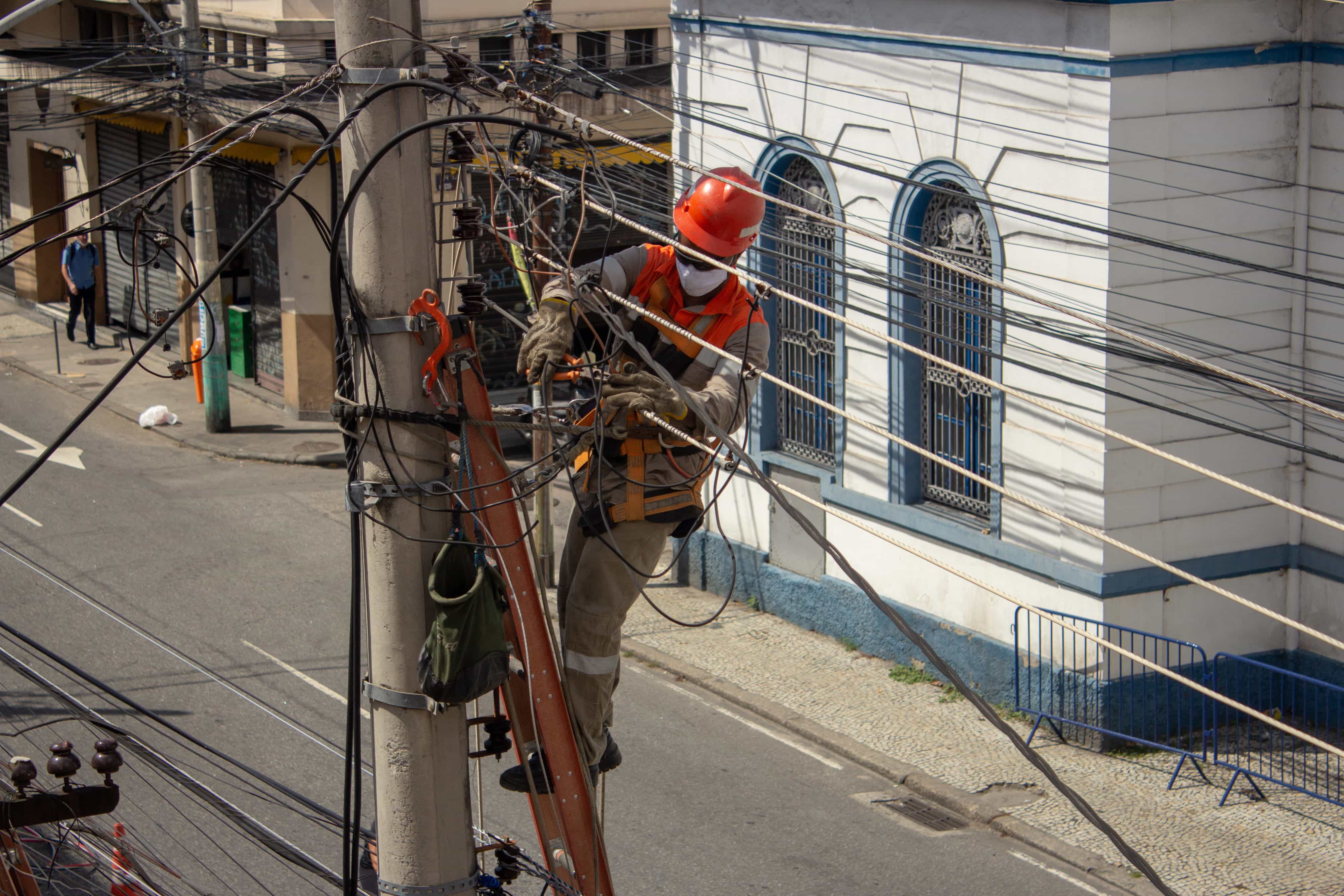 Men repairing electrical grid wires using masks because of COVID-19