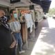 Restaurant workers Alvyn Lopez, left, and Maria Lindo watch for customers as they stand outside Aura at Books & Books, Monday, July 6, 2020, on Miami Beach, Florida's famed Lincoln Road. In Miami-Dade County, population 2.7 million, Mayor Carlos Gimenez ordered the closing of restaurants and certain other indoor places, including vacation rentals, seven weeks after they were allowed to reopen. Beaches will reopen on Tuesday after being closed over the weekend. (AP Photo/Wilfredo Lee)