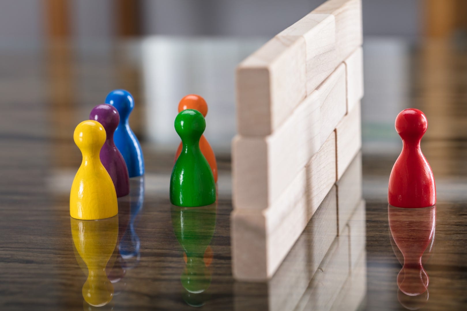 Red And Blue Figurine Paw Separated By Wooden Blocks