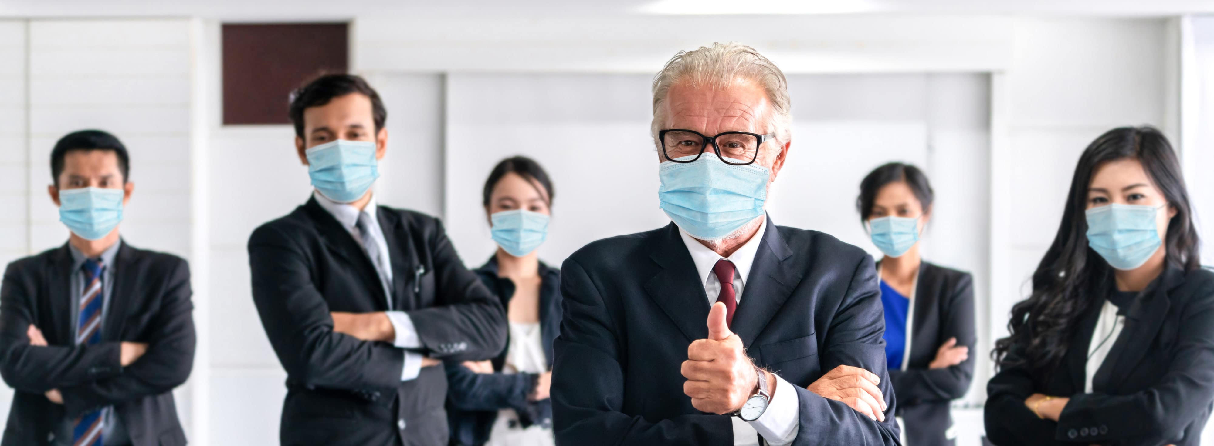 Confident business people with face mask protect from Coronavirus or COVID-19. Concept of help, support and collaboration together to overcome epidemic of Coronavirus or COVID-19 to reopen business.