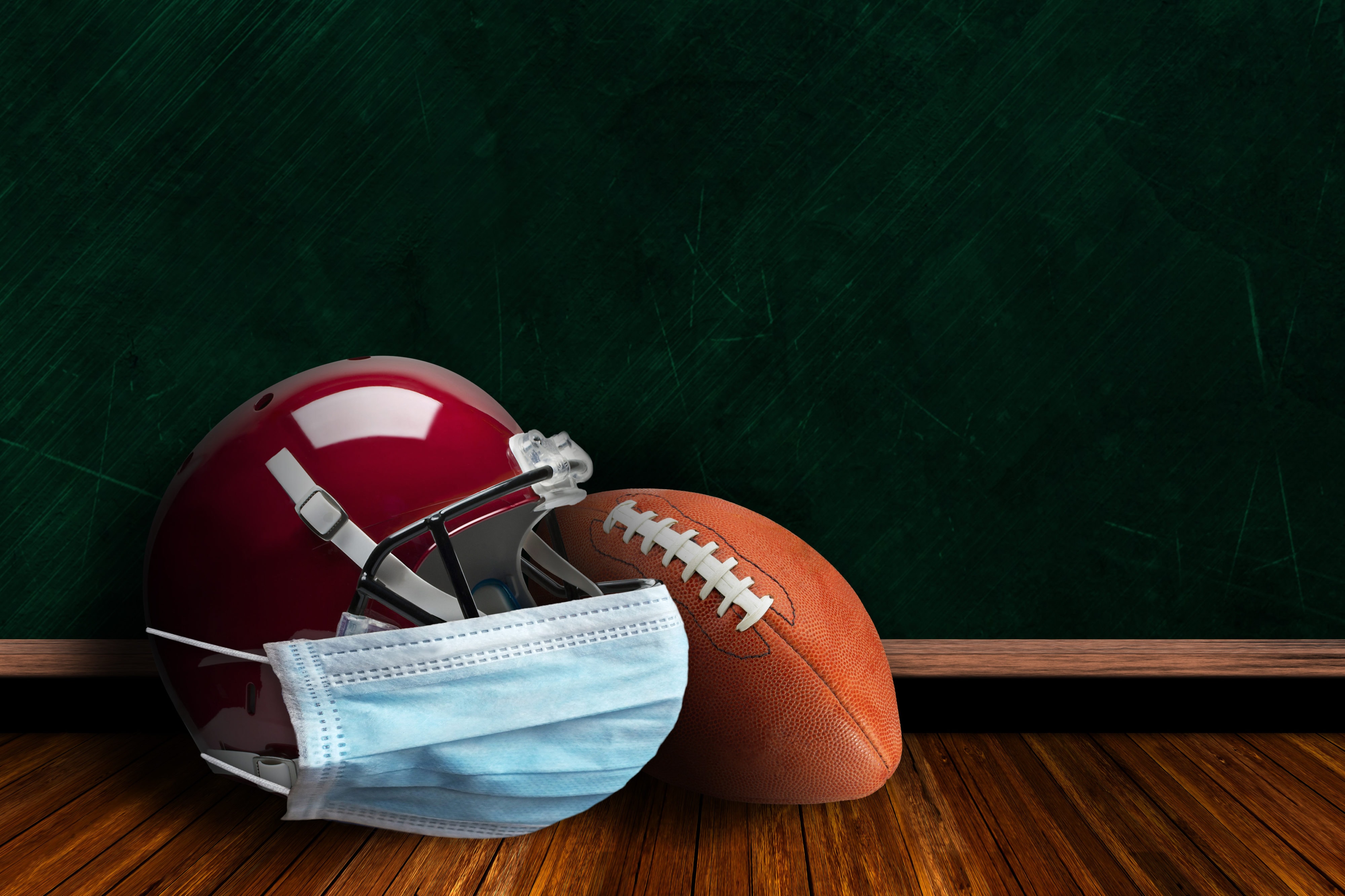 Football Helmet Wearing Mask With Chalkboard Background and Copy Space