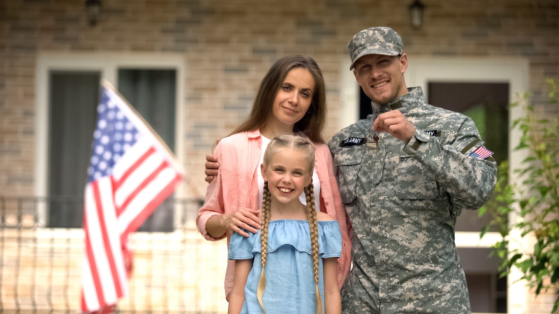 US military man with family showing keys from house, benefits in crediting