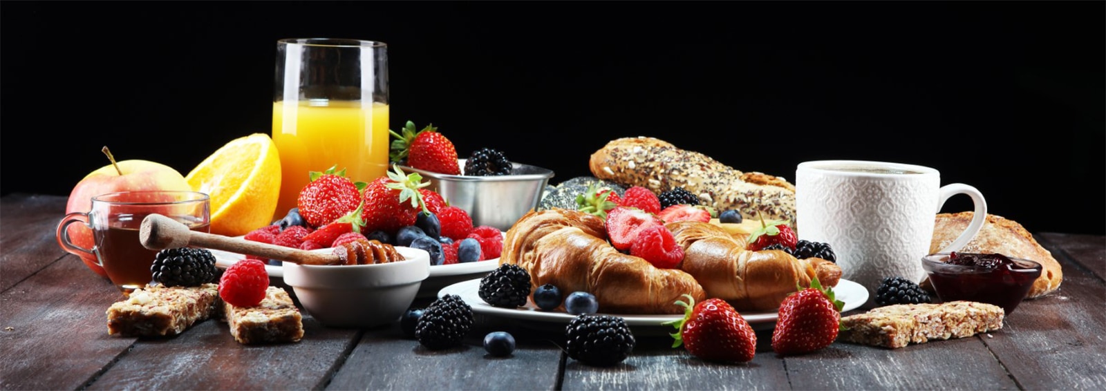 breakfast on table with waffles, croissants, coffe and juice