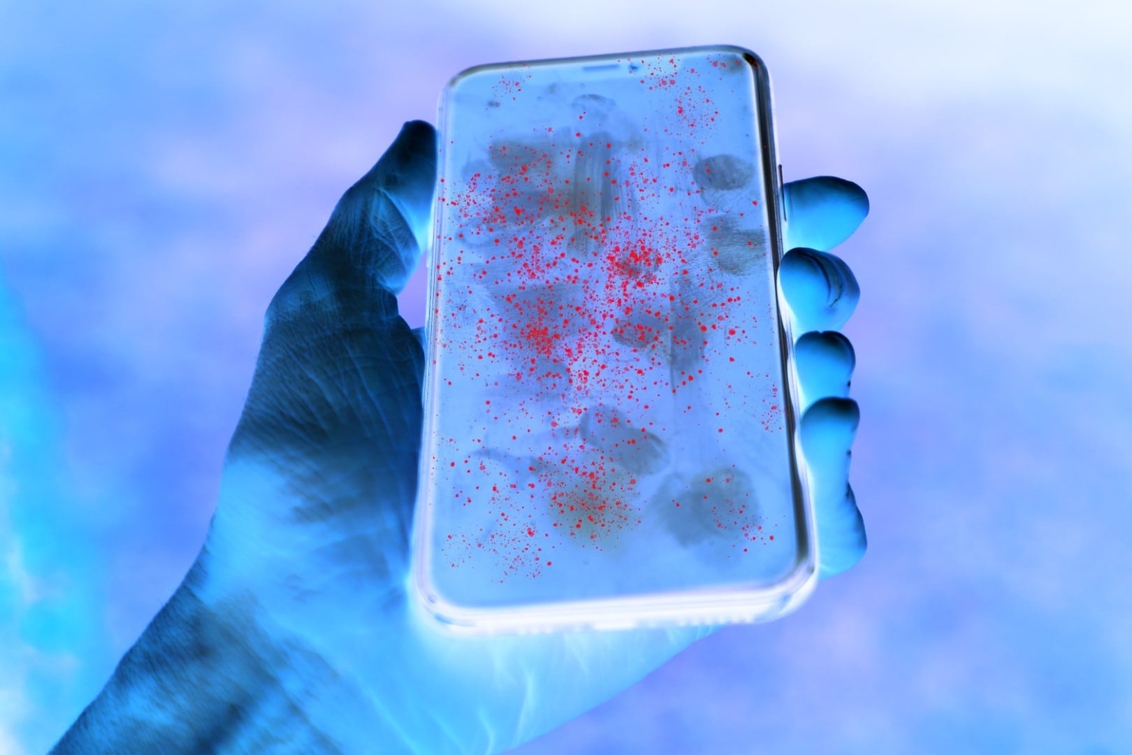 Dirty mobile phone screen with invisible germs shown in contrast