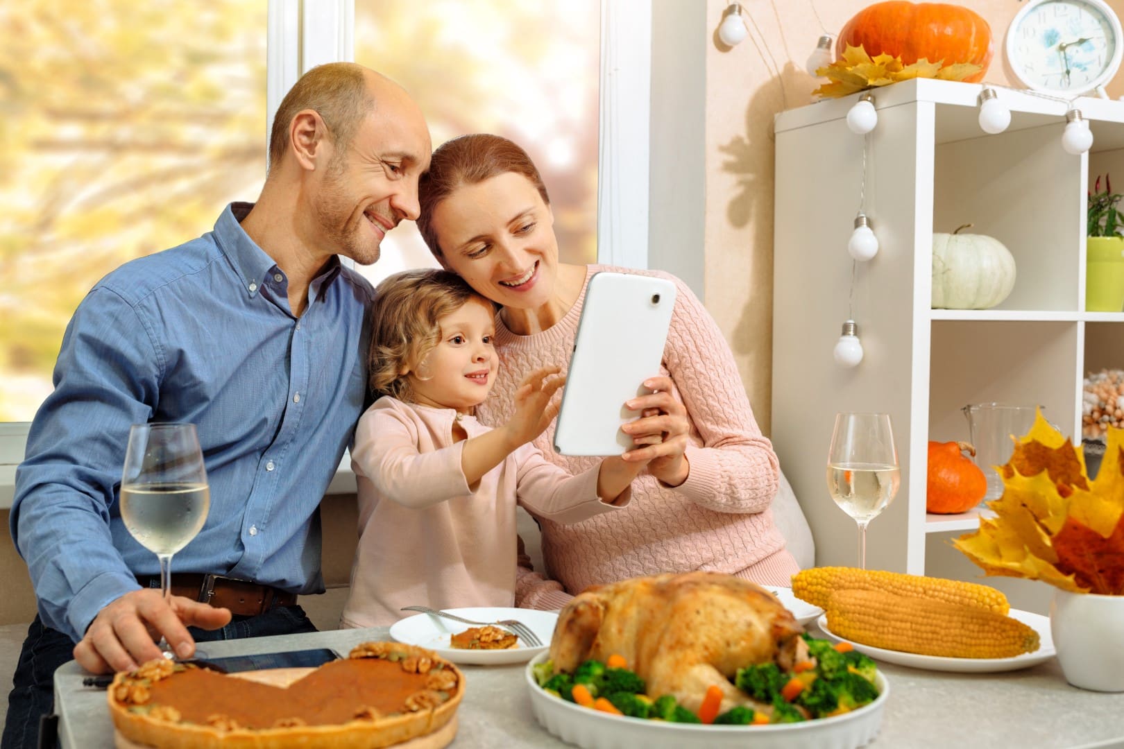 A happy family have a thanksgiving dinner and sends a video greeting to their parents.