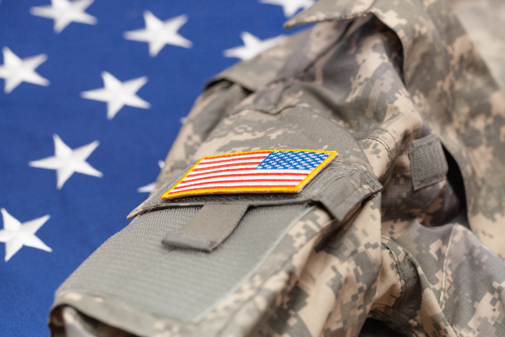 USA army uniform over national flag - studio shot