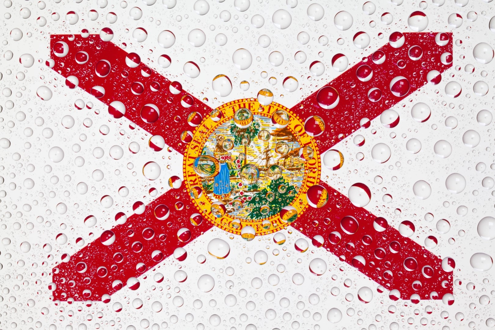 Flag of American State Florida behind a glass covered with rain drops.