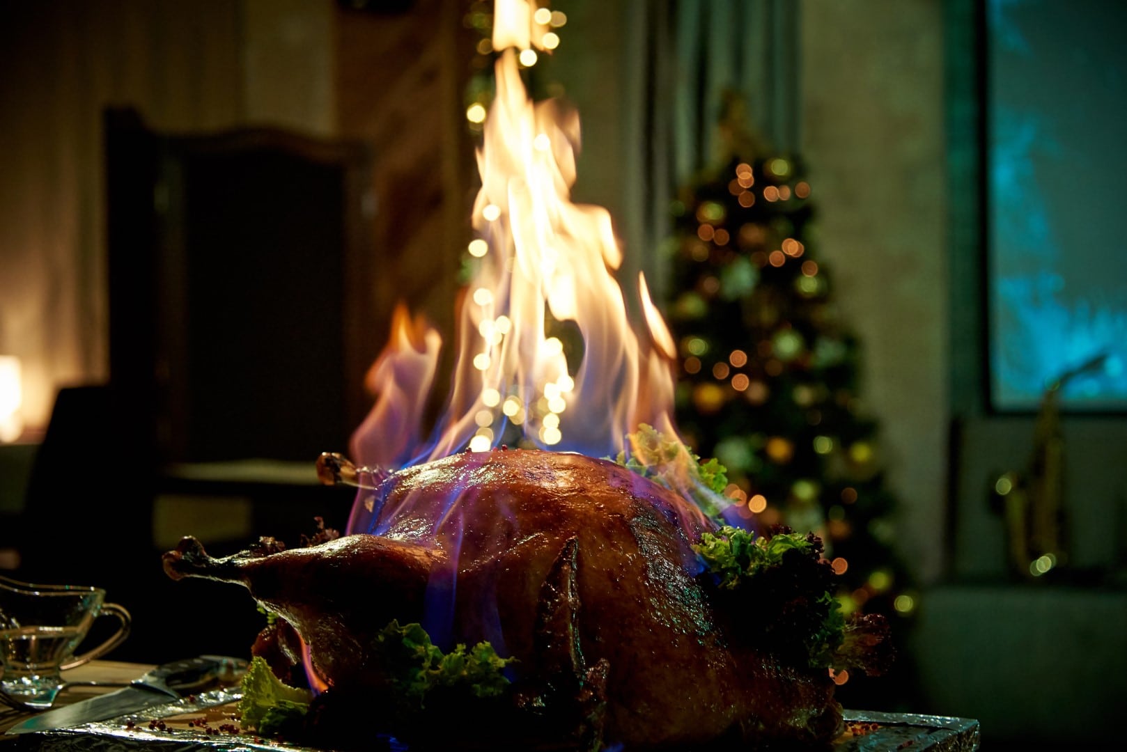 Burning baked turkey on a tray in a dimly lit room.