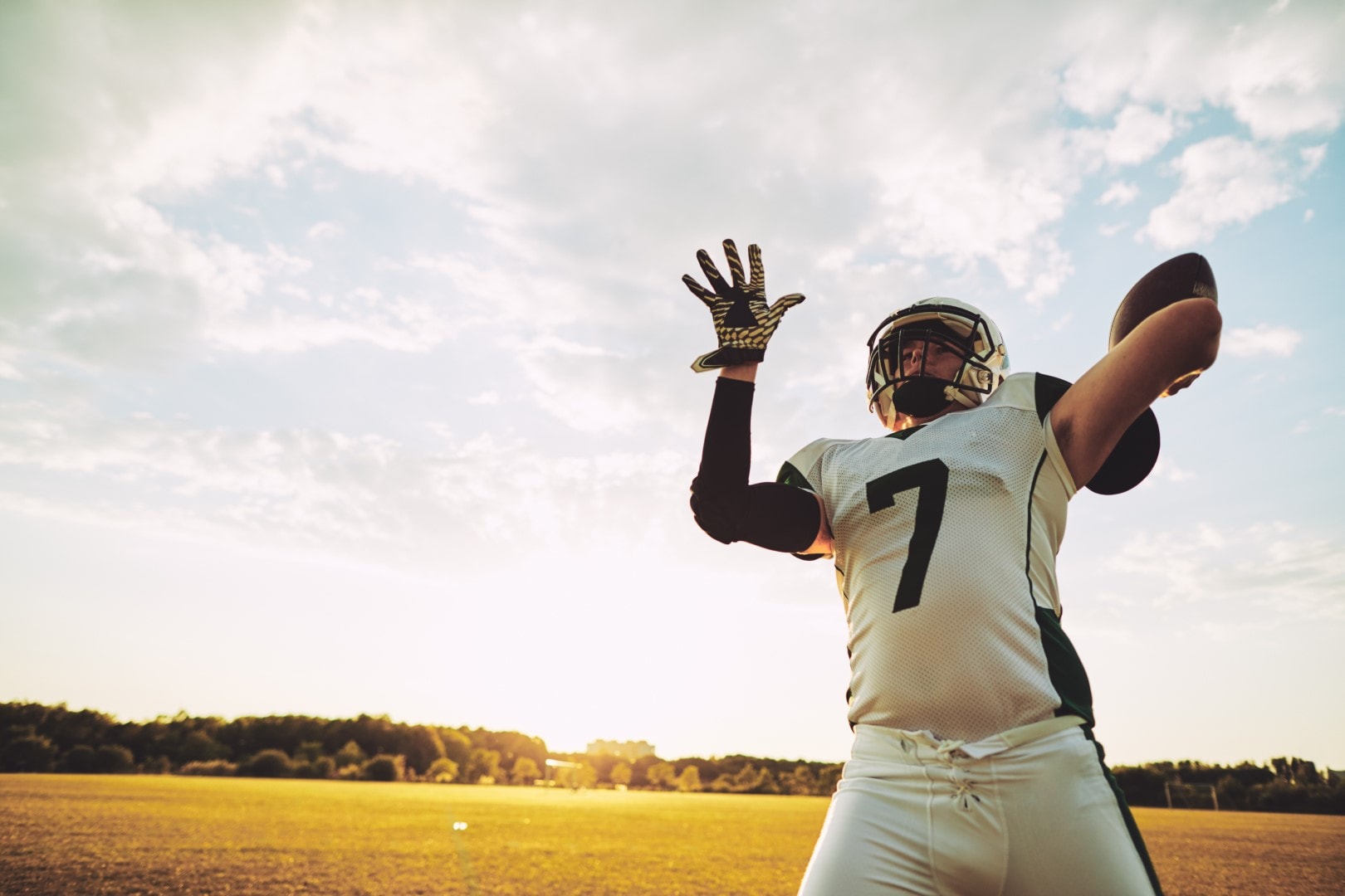 Football quarterback about to throw a pass during team practice