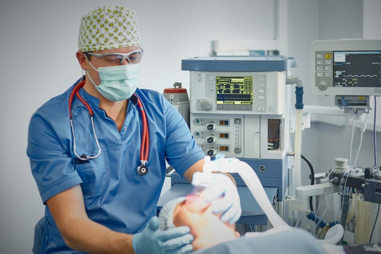 Several doctors surrounding patient on operation table during t