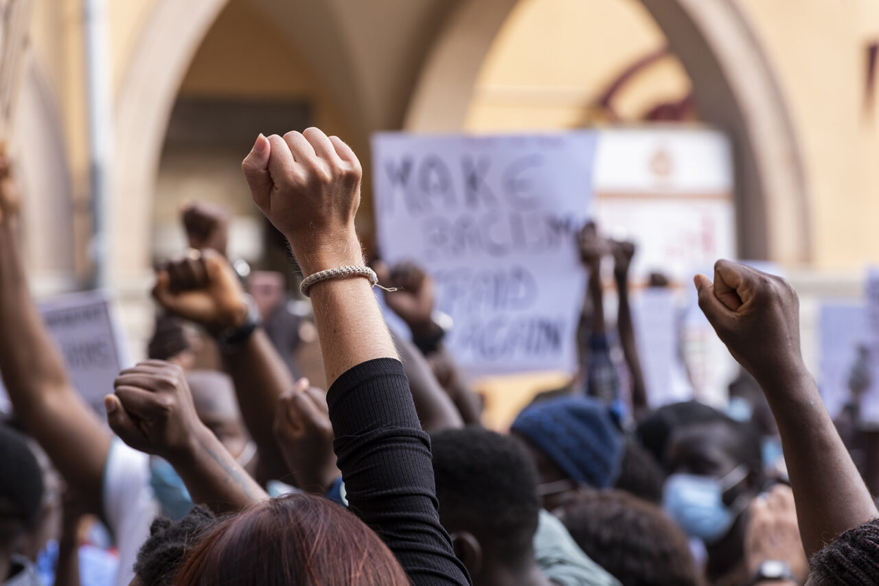 People raising fist with unfocused background in a pacifist prot