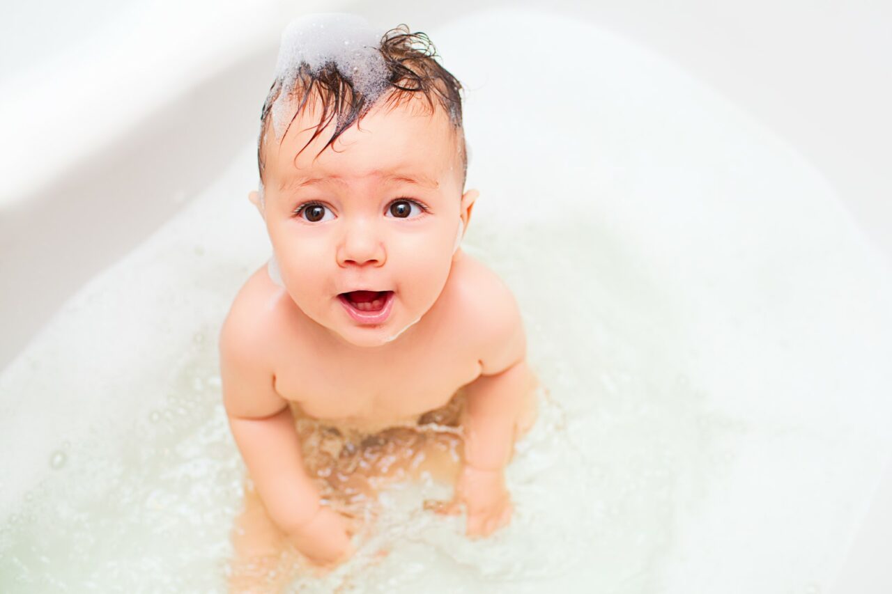 Little baby splashing in bath