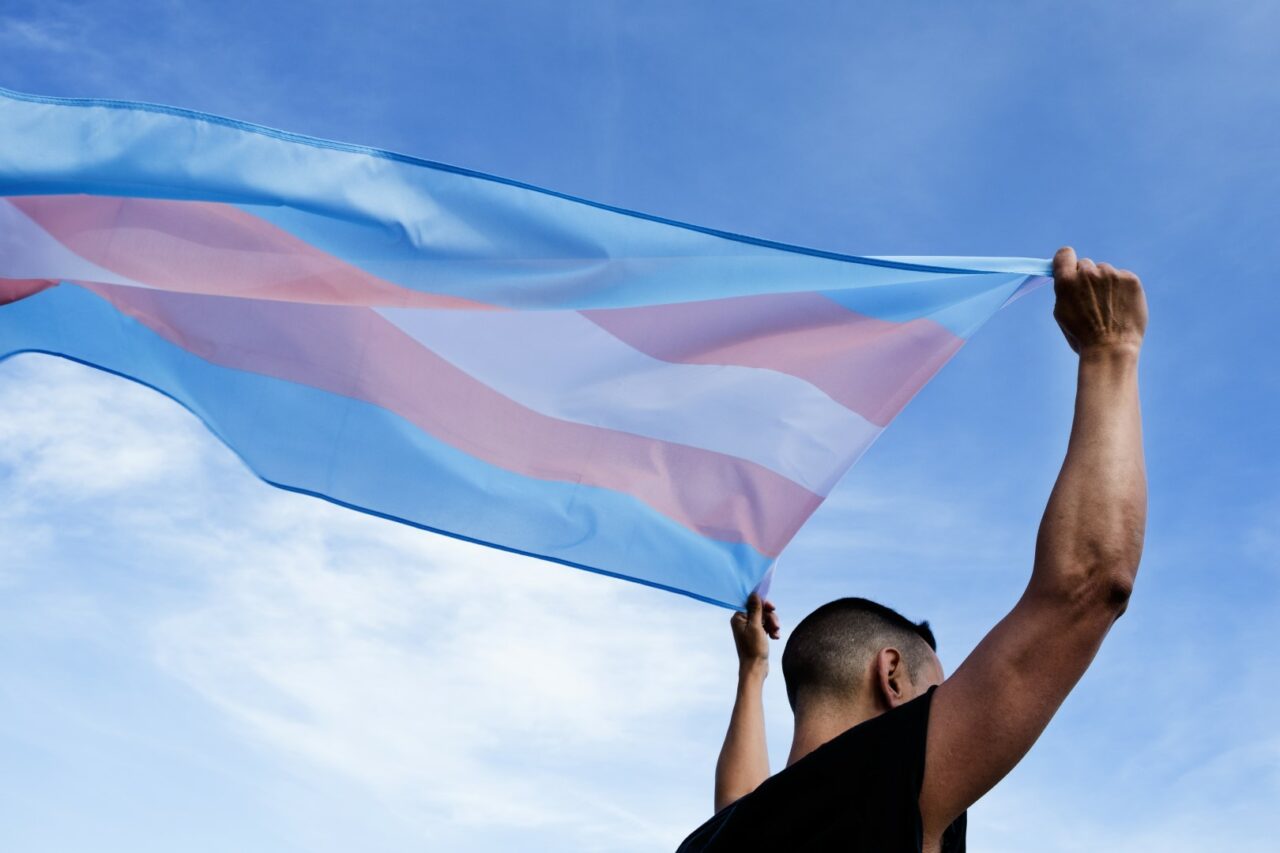 young person with a transgender pride flag