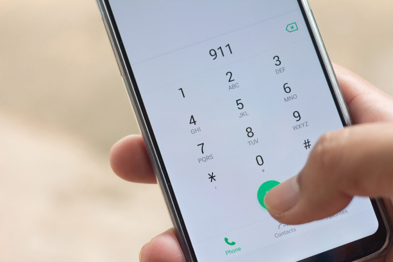 Emergency and urgency, dialing 911 on smartphone screen.