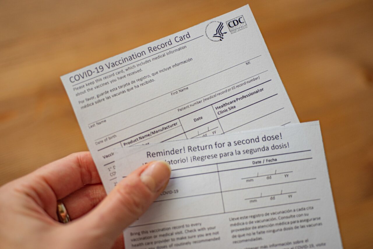 COVID-19 Vaccination Record card and reminder for a second dose. Part of Vaccination immune passport or international certificate.