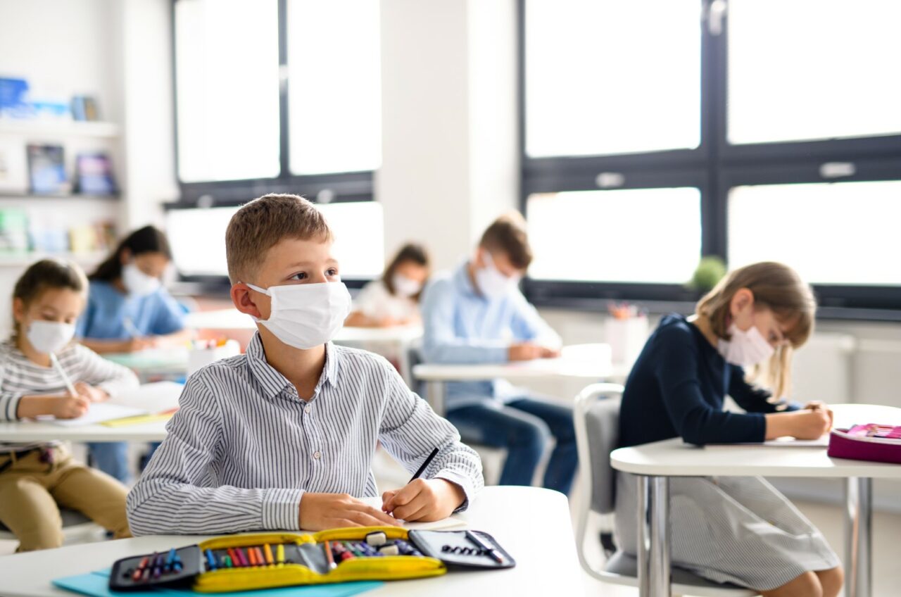 Children with face mask back at school after covid-19 quarantine and lockdown.