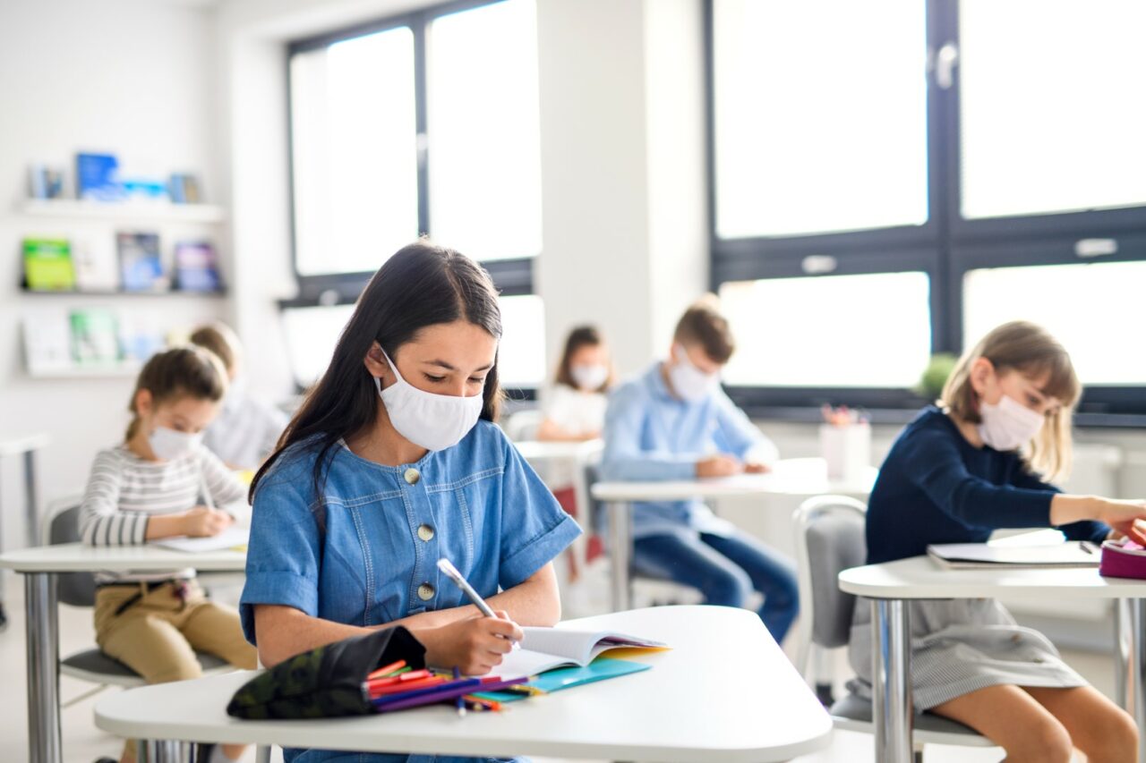 Children with face mask back at school after covid-19 quarantine and lockdown.