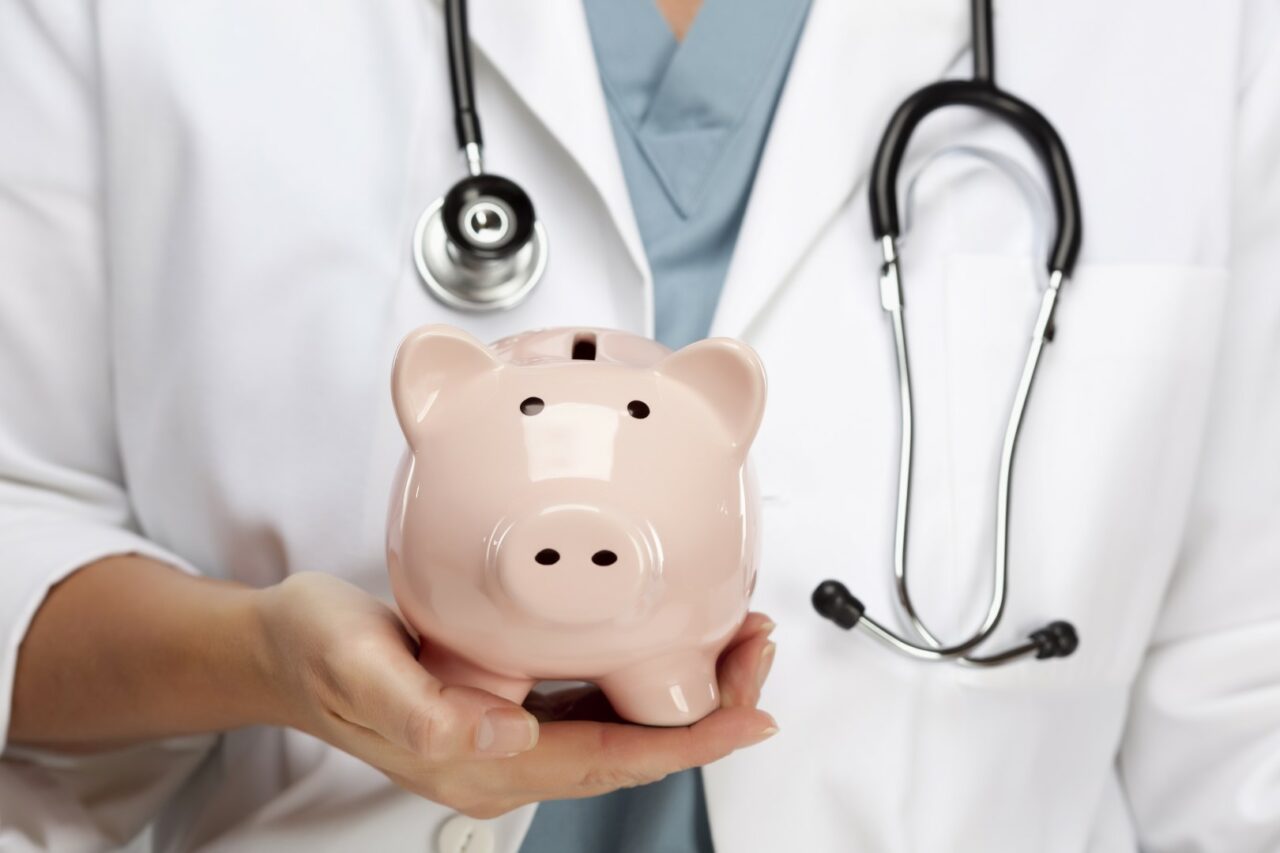 Female Doctor with Stethoscope Holding Piggy Bank Abstract.