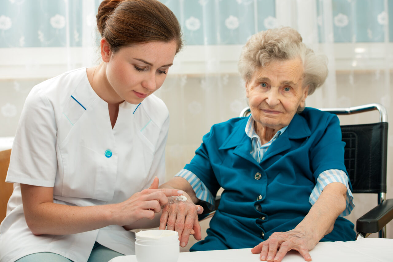 Elderly woman is assisted by nurse at home