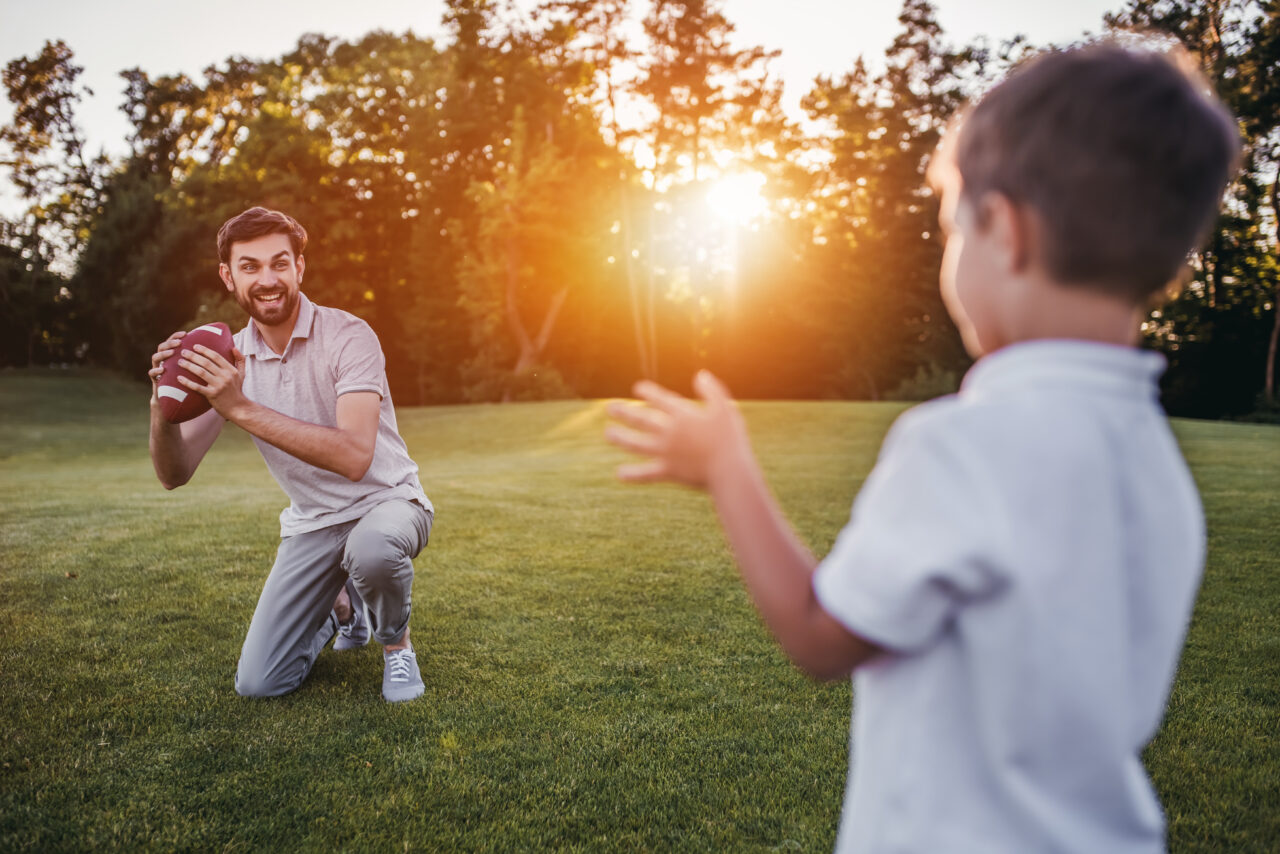 Dad with son playing American football