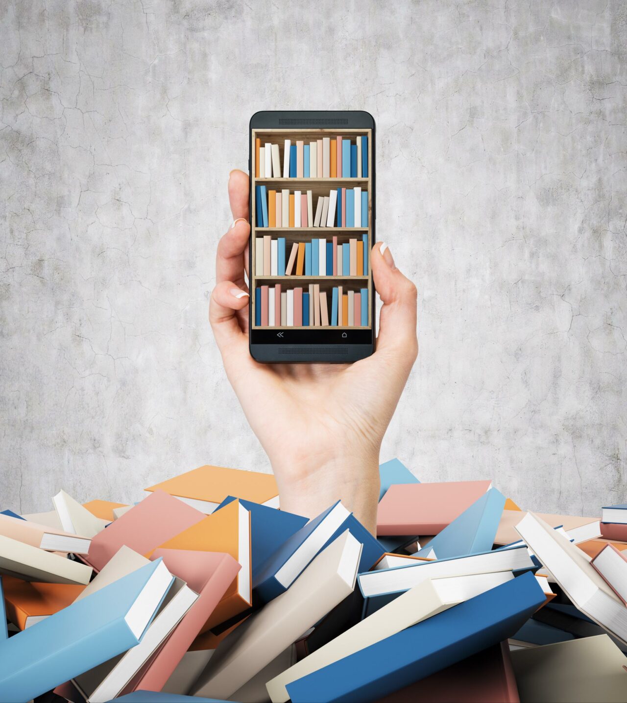 A hand holds a smartphone with a book shelf on the screen. A heap of colourful books. A concept of education and technology. Concrete wall background.